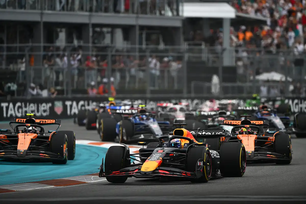 Max Verstappen leads both McLarens into Turn 1 at the start of the 2024 US Grand Prix as Lando Norris struggles for grip